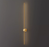 The copper rod lit against a dark wall, the warm metal catching the glow