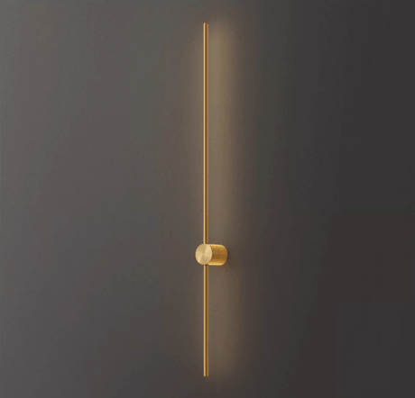 The copper rod lit against a dark wall, the warm metal catching the glow