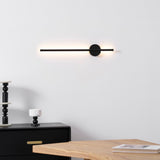 Lit in a bedroom corner above a dark cabinet holding a candlestick and books