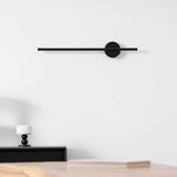 Mounted above a black nightstand with two candlesticks and a small tray