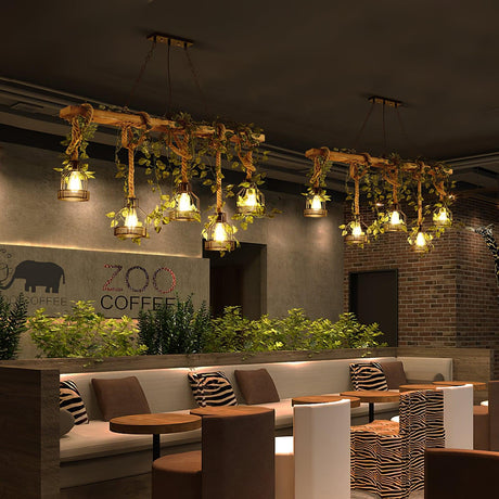 Two beams lit above booth seating and low tables in a cafe with planting