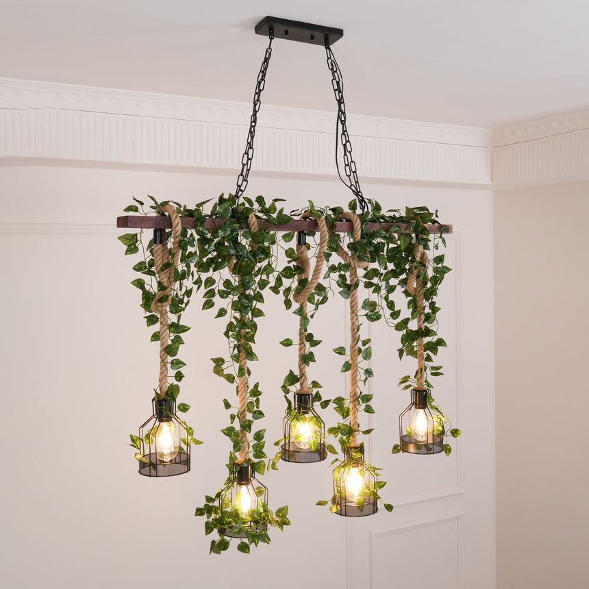 The beam lit in a pale room under a cornice, foliage hanging between the cages