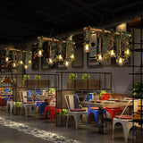 A row of them lit down a long restaurant with colored chairs and tables