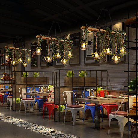 A row of them lit down a long restaurant with colored chairs and tables