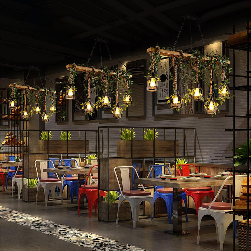 A row of them lit down a long restaurant with colored chairs and tables
