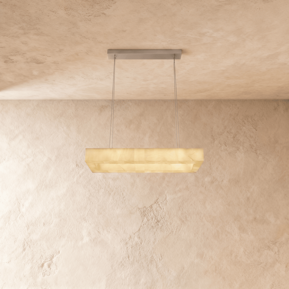 A long rectangular alabaster bar lit below a slim ceiling plate