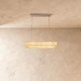 A long rectangular alabaster bar lit below a slim ceiling plate