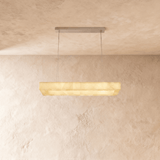 A lit alabaster bar seen straight on against a plaster wall