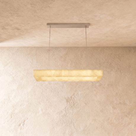 A lit alabaster bar seen straight on against a plaster wall