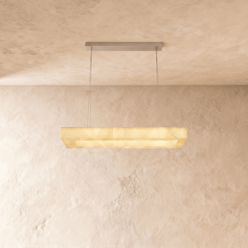 A lit alabaster bar seen straight on against a plaster wall