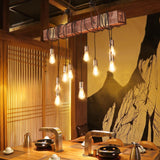 Lit above a counter beside a slatted timber screen with bowls set out below