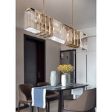 The bar lit above a dark dining table with chairs, a runner and two vases