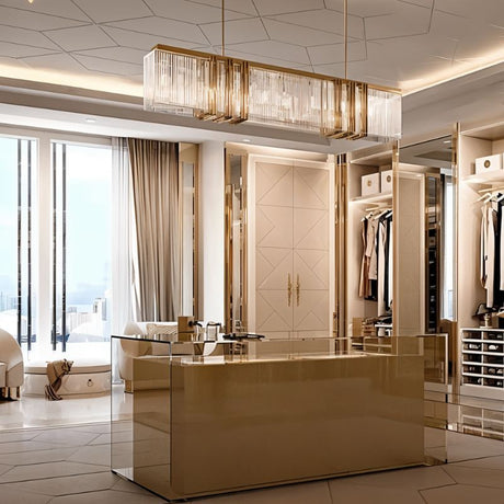 The lit bar above a gold kitchen counter in a room with floor to ceiling windows