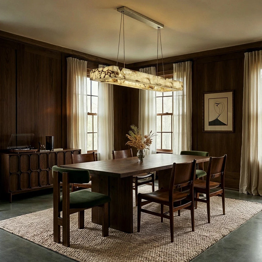 A lit bar above a dining table in a dark paneled dining room