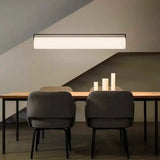 The flat lit bar hung under a sloped ceiling above a table and chairs