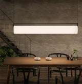 The flat lit bar hung above a wooden table beside a window