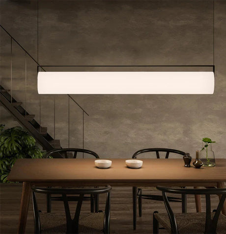 The flat lit bar hung above a wooden table beside a window
