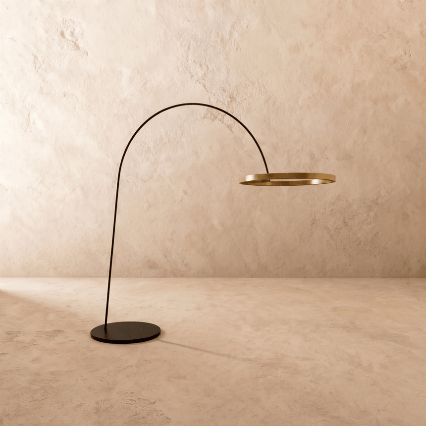 The gold ring and curved arm at an angle, the flat round base on the floor