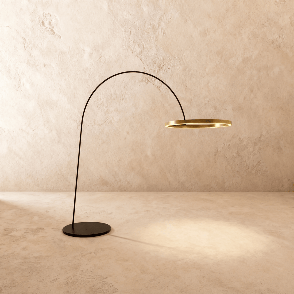 A thin black arm curving from a flat disc base to a lit gold ring at its end