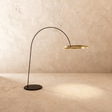 A thin black arm curving from a flat disc base to a lit gold ring at its end