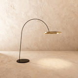 A thin black arm curving from a flat disc base to a lit gold ring at its end