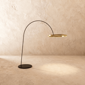 A thin black arm curving from a flat disc base to a lit gold ring at its end