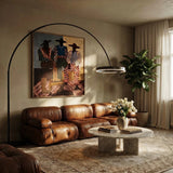 The gold ring lit over a leather sofa in a living room with artwork and a plant