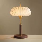 Remote control table lamp lit and seen in full against a plain ground