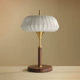 Remote control table lamp unlit against a plain warm ground