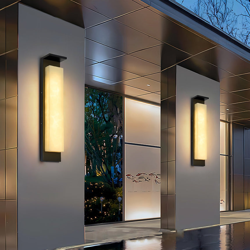 Panel lights on the pillars of a covered walkway beside a reflecting pool