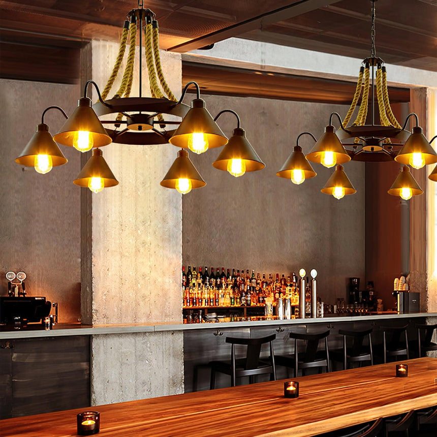 Two of the chandeliers lit above a long bar counter and stools