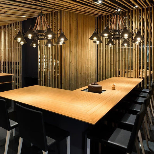 The fitting lit above a long wood table in a slatted wall room