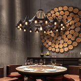 Chandelier lit above a round dining table set for four people