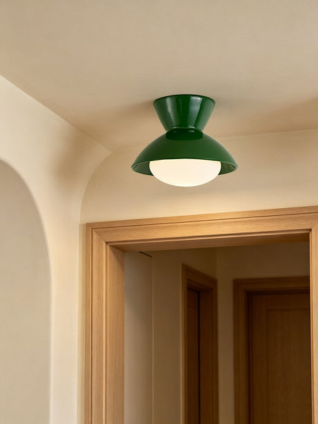 Green gourd ceiling light on a plaster ceiling beside an arched doorway