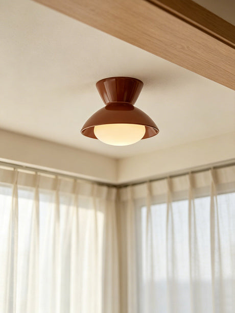 Terracotta red gourd ceiling light near a curtained window