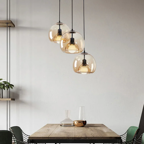 Amber and smoke domes above a dining table set with a carafe and glasses