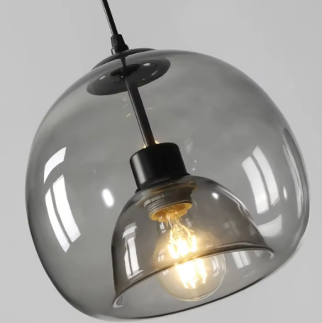Smoke gray glass dome lit with a visible filament bulb inside it