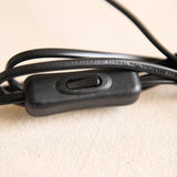 Close view of the inline rocker switch on the black cord