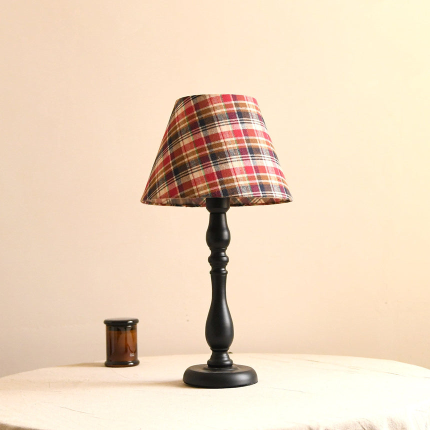 Table lamp with a checked plaid shade on a turned black base