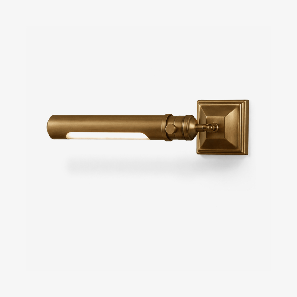 Brass tube on a stepped square base, the tube reaching out from the wall