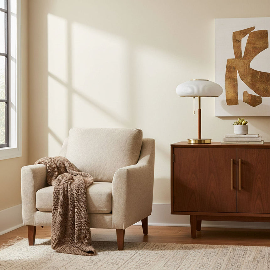 Ribbed glass table lamp on a wood sideboard in a pale room