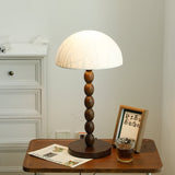 Rice paper table lamp lit beside a small framed print on a table