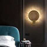 The ring lit beside a teal headboard above a small nightstand