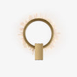 Gold ring wall light fringed with clear crystal points, lit from within