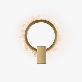 Gold ring wall light fringed with clear crystal points, lit from within