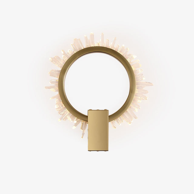Gold ring wall light fringed with clear crystal points, lit from within