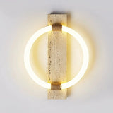 Front view of the lit ring, the warm light washing the stone and the wall around it