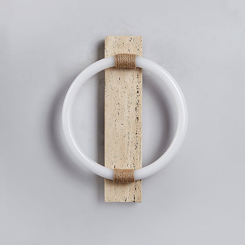 The white ring and the travertine slab with the light off, the rope wraps at top and bottom