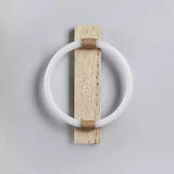 The sconce unlit, a white acrylic ring around a pale travertine slab with rope bands