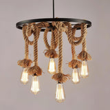 The eight light build lit warm, swags ringed around the iron frame